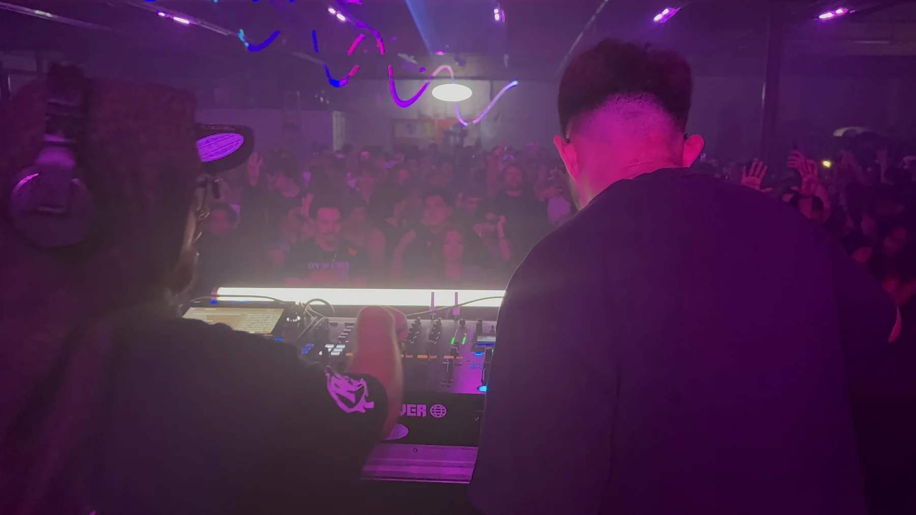 Jason Bleu behind the decks facing the crowd